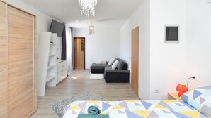 A modern bedroom with a bed, a wardrobe, a sofa, and a desk. - House 1790 (Medulin)
