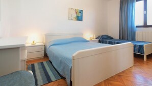 A bedroom with two beds, a desk, and a chair. - Apartment 1794 (Liznjan)