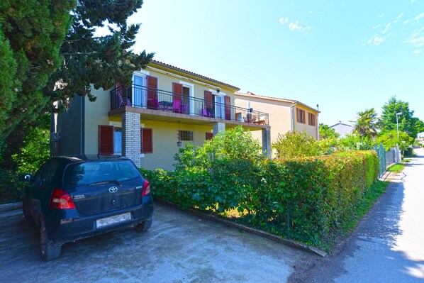 A two-story building with a balcony on the upper floor.
