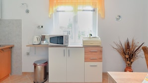 A compact kitchen with a microwave, kettle, and a small cabinet. - Apartment 1822 (Pula)