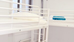 A bunk bed room with white bedding and a window. - Hostel 18 (Madrid)