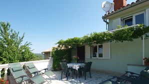 A patio with a table and chairs, a satellite dish, and a view of the countryside. - Apartment 1895 (Marcana)