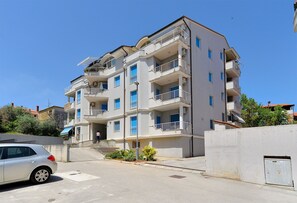 Residents enjoy balconies and access to a driveway.