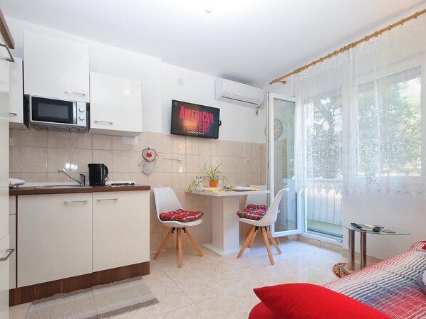 Enjoy meals in the kitchen with microwave and adjacent dining area with table and chairs.