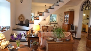 A cozy living room with a staircase, a dining area, and a kitchen. - Peaceful Villa Stay in Rapallo (Rapallo)
