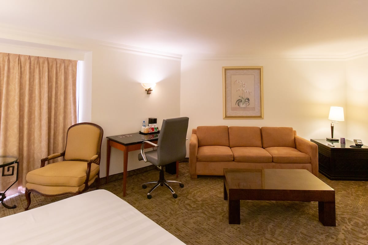 junior room, 1 king bed | living area | 40-inch flat-screen tv with cable channels