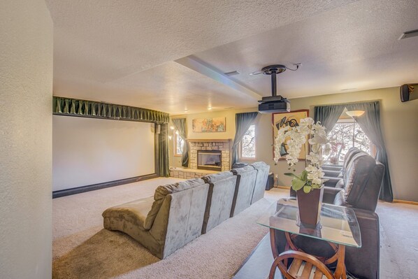 A living room with a fireplace, a sofa, a glass coffee table, and a TV.