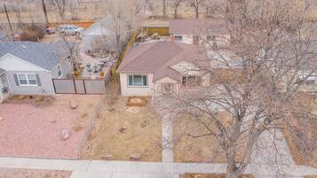 A residential area with houses, a patio, and a tree.