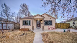 A single-story house with a front porch, a mailbox, and a small garden area. - Stir Crazy! Bike Trails, Dogs OK, Food & Nightlife (Colorado Springs)