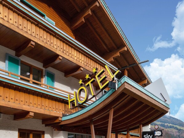 A hotel with a wooden facade, balconies, and a sign indicating the name. - Apartment in Wald Near Zillertal Ski Slopes (Wald im Pinzgau)