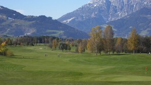 A golf course with a mountainous backdrop. - Boutique Chalet in Maria Alm near Hochkönig (Maria Alm am Steinernen Meer)