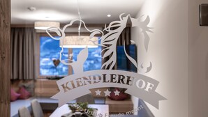 A cut-out sign with the text "KINDLERHOF" and "Wo Urlaub Freude macht" in a modern interior setting. - Farmhouse in Schwendau With Balcony (Schwendau)