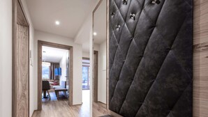 A modern hallway with a bench, wooden flooring, and a tufted headboard. - Farmhouse in Schwendau With Balcony (Schwendau)