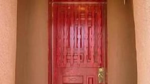 A red door with a brass doorknob and a small window above it. - Casita I - 2 Bed, 2 Bath (Santa Fe)