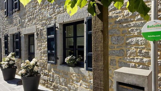 A stone building with black shutters and potted plants. - Charming Cottage in a Farm With Views (Doische)