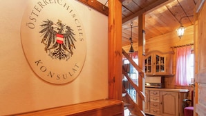 A wooden interior with a staircase leading to a kitchen area. - Chalet Near Lake Klopeiner With Sauna (Feistritz ob Bleiburg)