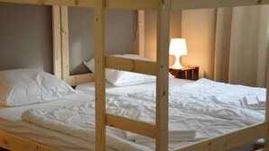 A bunk bed with white bedding and a bedside lamp. - Spacious Holiday Home in Voeren With Spacious Garden (Voeren)