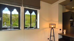 Eine moderne Küche mit einem großen Fenster, einer Stehlampe und einer Bar.
