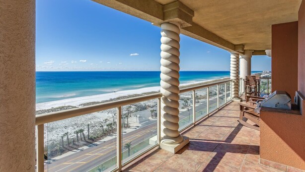 Een balkon met uitzicht op een strand en de oceaan.