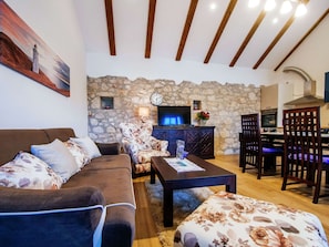 Relax in this inviting living room with a sofa, coffee table, and fireplace.