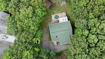 Surrounded by lush forest, this secluded home offers a natural retreat with a green roof and outdoor deck.