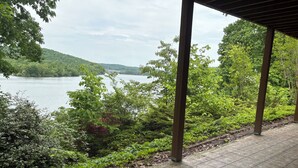 A covered outdoor area with a view of a lake and surrounding greenery. - Breathtaking Lake View w/Pool Nearby!- Knoxville/Oak Ridge (Knoxville)