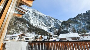 A mountain village with wooden buildings and a snowy mountain backdrop. - Sunlit Apartment near Ski Area in Längenfeld (Laengenfeld)