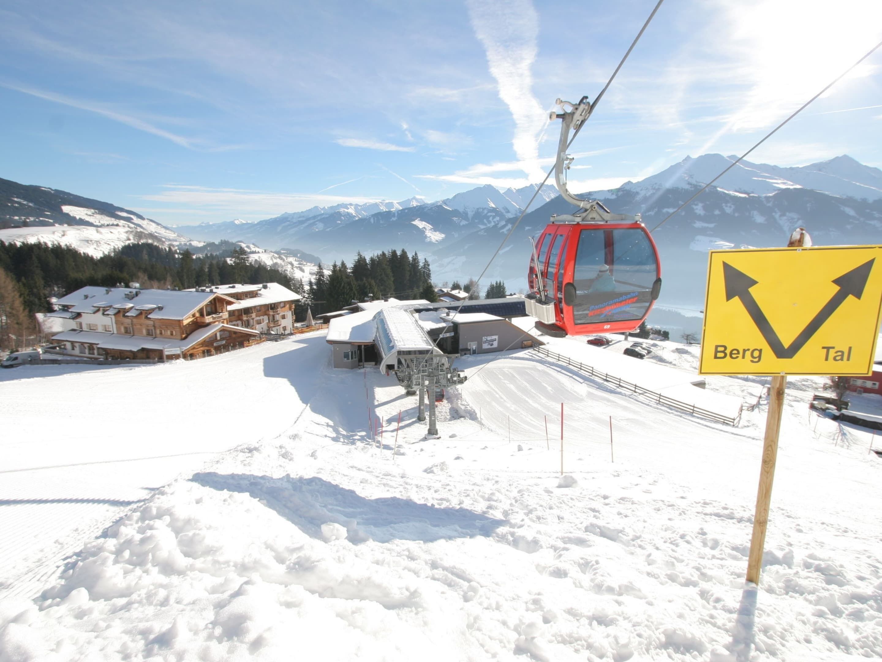 A ski lift with a sign indicating directions to Berg and Tal.