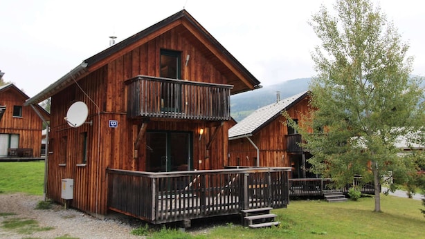 A wooden cabin with a balcony, a satellite dish, and a sign with the number 123. - Chalet in Stadl an der Mur / Styria Near ski Area (Stadl-Predlitz)