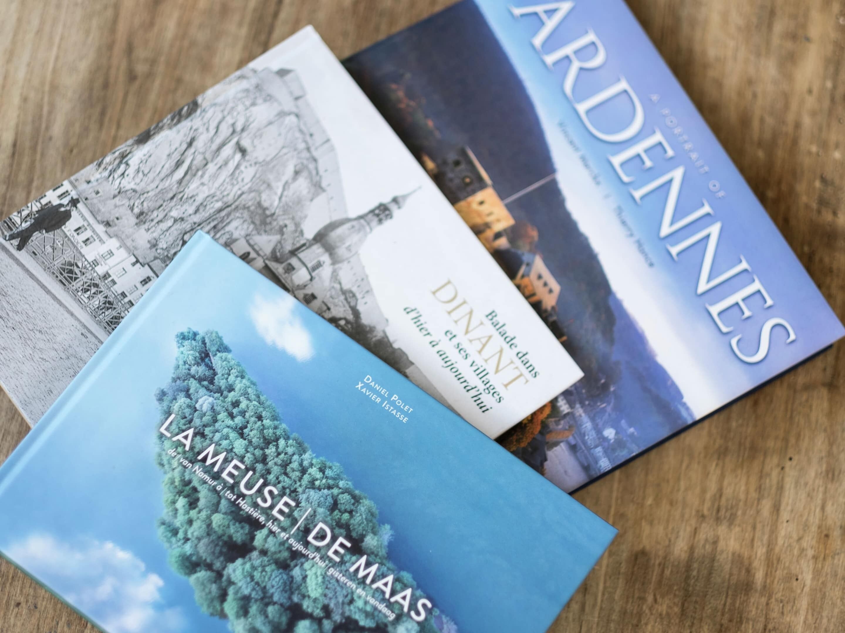 Three books with covers depicting landscapes and architecture.