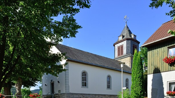 A church with a clock tower, stone walls, and a cobblestone street. - Holiday in the Sauerland Region in Unique Location (Willingen)