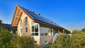 A house with a sloped roof, large windows, and solar panels. - Fantastic Holiday Home in Schonsee, Bavaria (Schoensee)