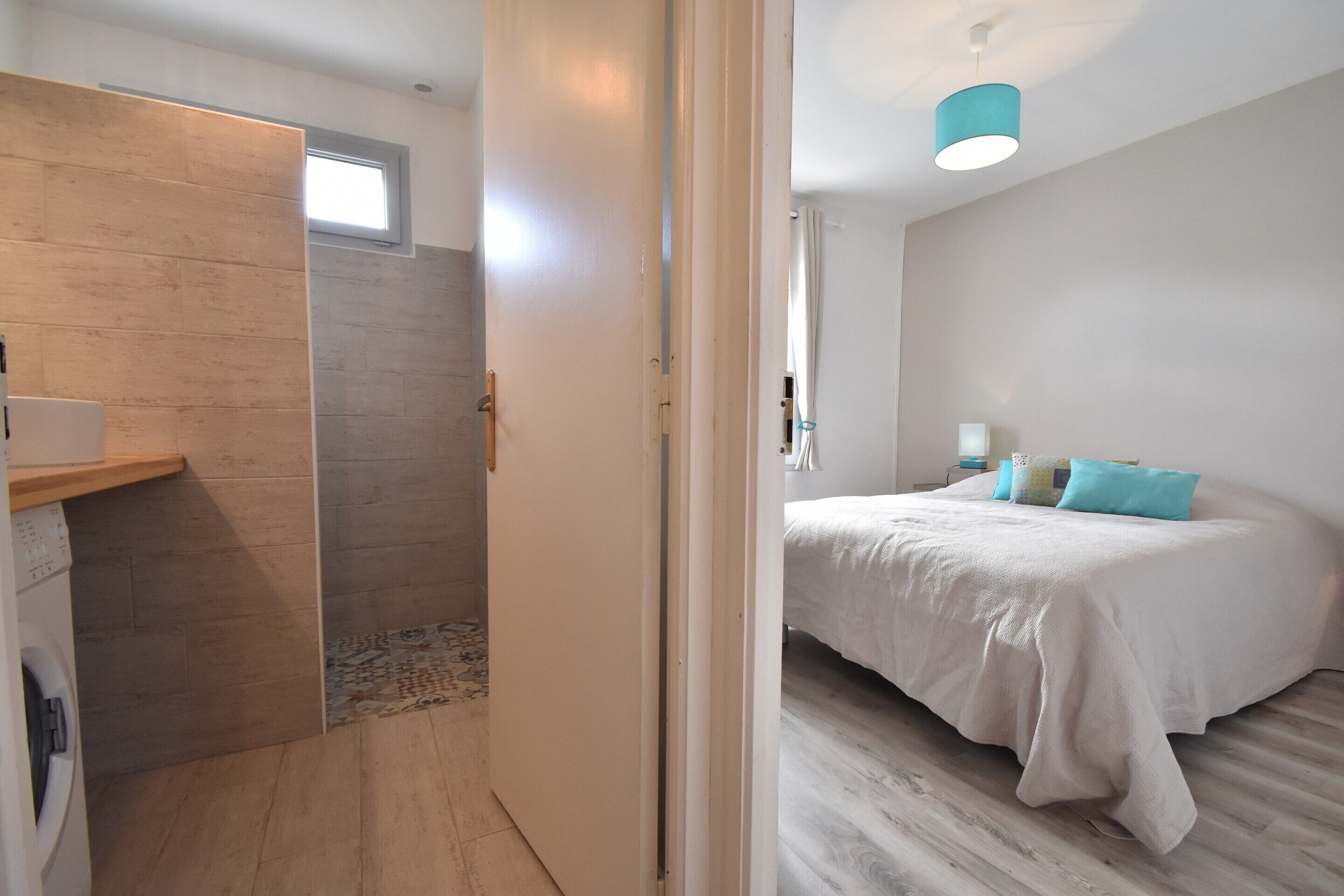 Una camera da letto con un letto, una finestra e un accesso a un bagno.