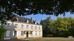 A two-story building with a symmetrical facade, a central entrance with steps, and a small porch area. - House in Burgundy With Private Pool (Saint-Aubin-sur-Loire)