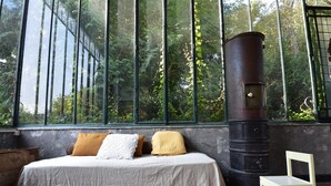 A room with a bed, a chair, a large window, and a vintage-style heater. - House in Burgundy With Private Pool (Saint-Aubin-sur-Loire)