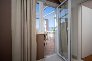 Enjoy a scenic view of the distant mountains from the balcony, complete with a dining table and chairs.