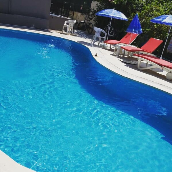 Seasonal outdoor pool, pool umbrellas, pool loungers