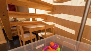 A room with wooden furniture, a plastic storage container, and a window casting shadows. - Chalet in Hohentauern Near Ski Lift (Hohentauern)