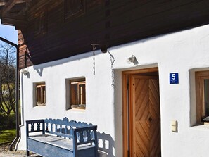 A building with a wooden door, a bench outside, and a number sign indicating room 5. - Holiday Home in Konzell With Terrace (Konzell)