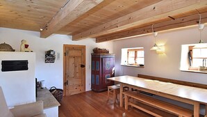 A rustic kitchen with wooden beams, a wooden table, and a bench. - Holiday Home in Konzell With Terrace (Konzell)