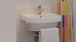 A bathroom with a white sink, chrome faucet, and a towel hanging on a rack. - Beautiful Holiday Home Near Lawn Bowling in Krabbendam (Warmenhuizen)