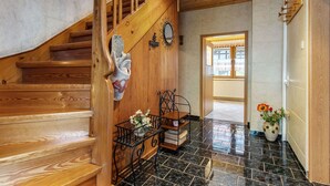 A wooden staircase with a handrail, a metal bench, and a potted plant. - Holiday Home in Thuringia With Private Terrace, use of a Garden and Pool (Roemhild)