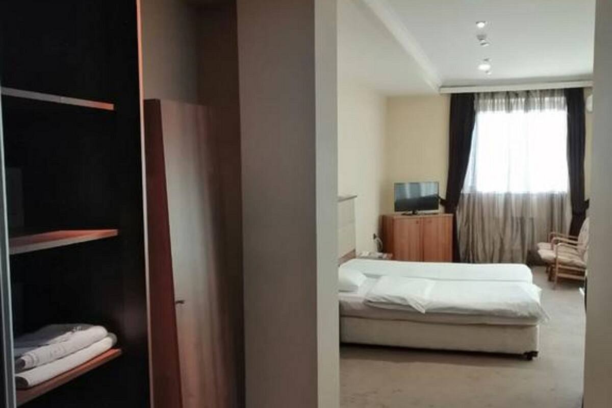 Desk, laptop workspace, iron/ironing board, bed sheets