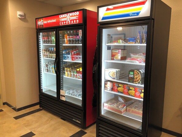 Two vending machines with various beverages and snacks.