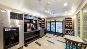 A clean, modern ice dispenser and refrigerated beverage display in a well-lit area with tiled flooring. - Candlewood Suites Panama City Beach Pier by IHG (Panama City Beach)