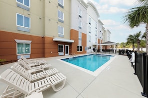A hotel pool area with lounge chairs and a covered seating area. - Candlewood Suites Panama City Beach Pier by IHG (Panama City Beach)
