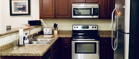 Microwave, dishwasher, coffee/tea maker, cookware/dishes/utensils