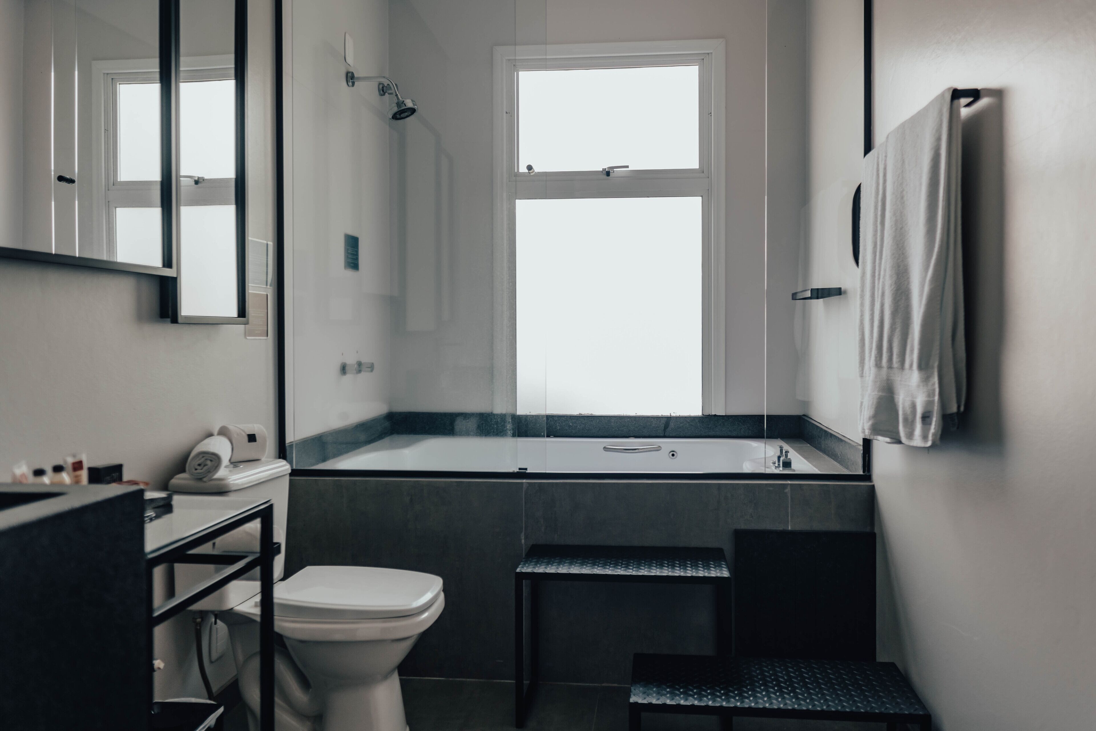 A modern bathroom with a toilet, sink, and bathtub.