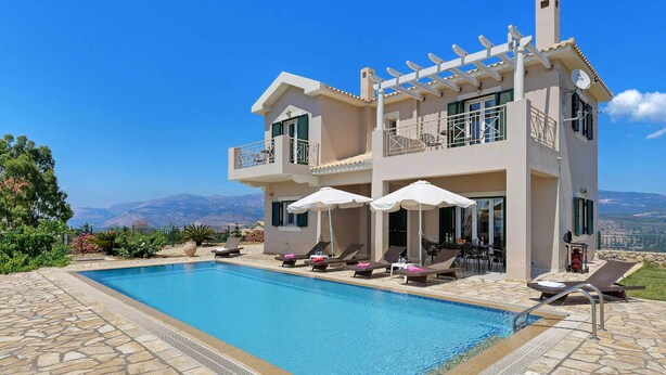 A two-story building with a swimming pool, outdoor seating, and a mountain view. - Villa Kalithea - Three Bedroom Villa, Sleeps 7 (Argostolion)