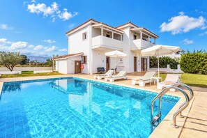 A two-story house with a swimming pool, outdoor furniture, and a clear sky. - Villa Rodi - Four Bedroom Villa, Sleeps 9 (Zakynthos)